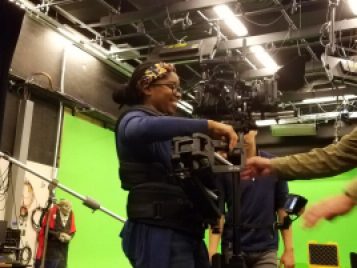 Al Young helps Aliyah Mitchell with the VariZoom Blackhawk Camera Stabilizer  